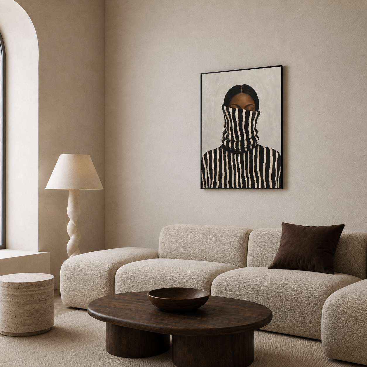 Black woman abstract and neutral portrait displayed above a beige sofa in a minimalist living room
