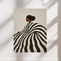 Black woman striped portrait poster displayed on a light neutral wall.Black woman striped portrait poster displayed on a light neutral wall.