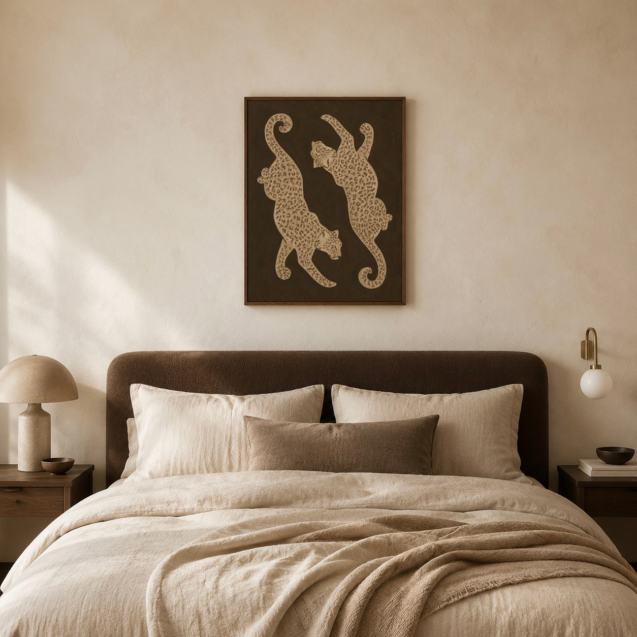Neutral leopard poster displayed above a beige and brown bed