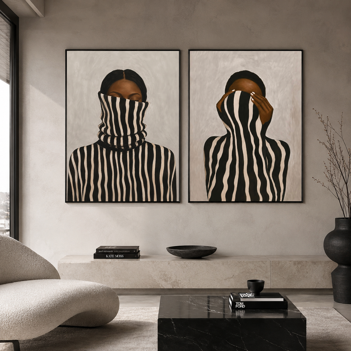 Set of two modern Black woman portraits in black frames in a minimalist living room.