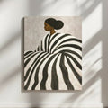 Afrocentric black woman art print with bold black and white striped portrait on a neutral wall