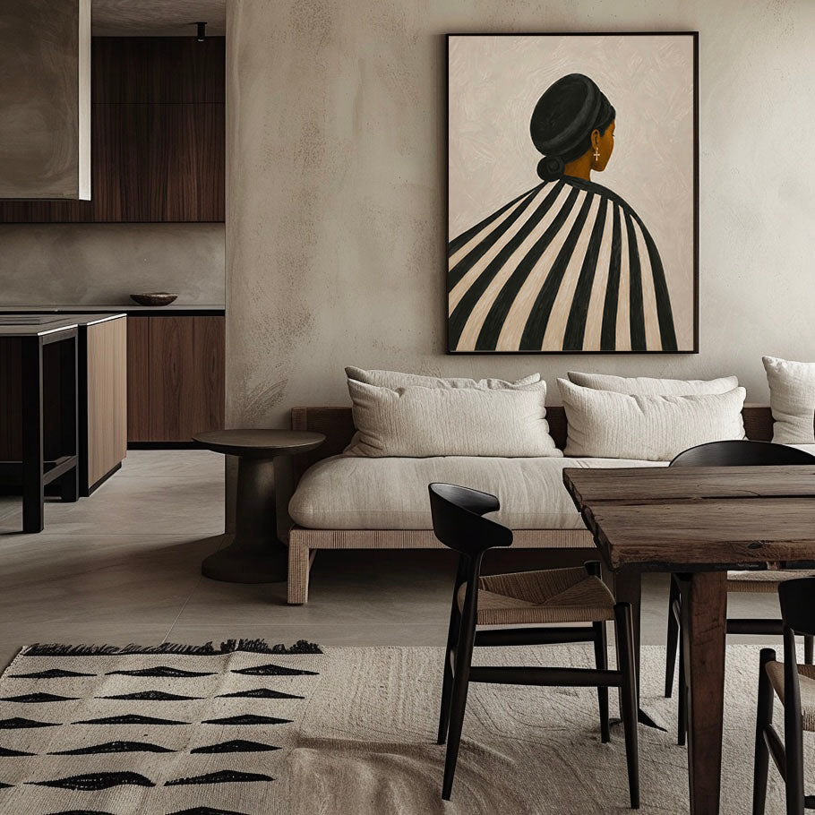 Framed Black woman striped wall art displayed above a neutral sofa in a modern living room