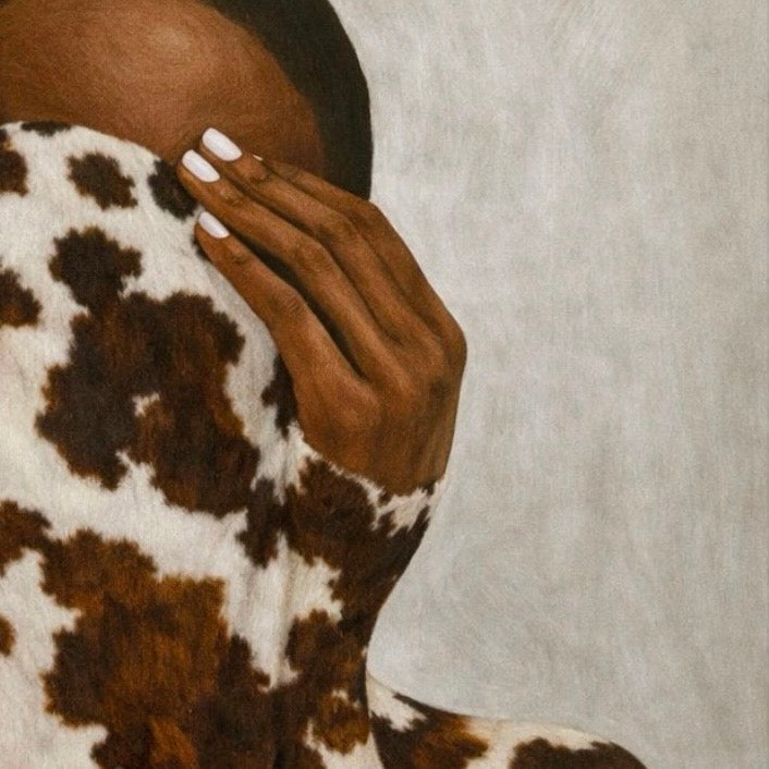 Close-up detail of an Afrocentric abstract artwork showing cowhide-inspired patterning and hand-painted texture, highlighting warmth, tactility, and natural symbolism.